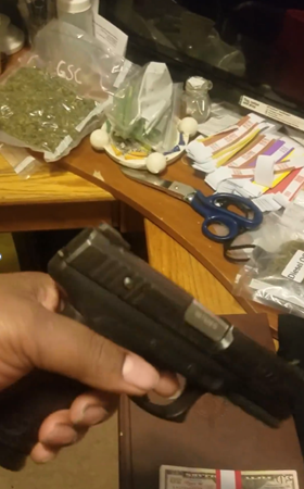 Photo from the defendant’s email account showing a firearm and marijuana in the background
