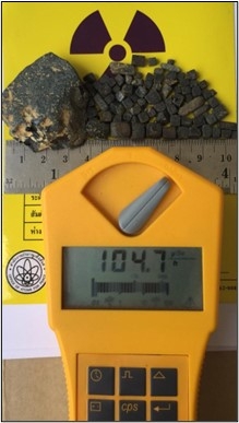 Photo sent by the defendant depicting rock substances with Geiger counters measuring radiation