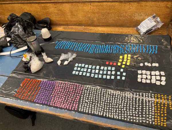 Photo of suspected narcotics, narcotics paraphernalia, and materials designed for use in packing narcotics for distribution