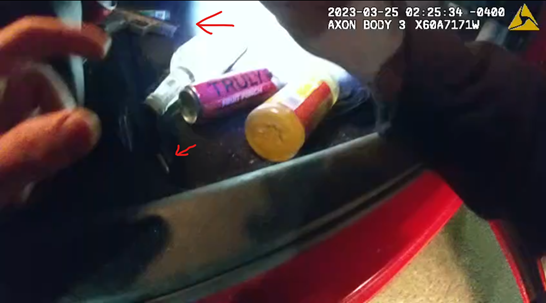 Image of handgun and a stray round of ammunition under car seat