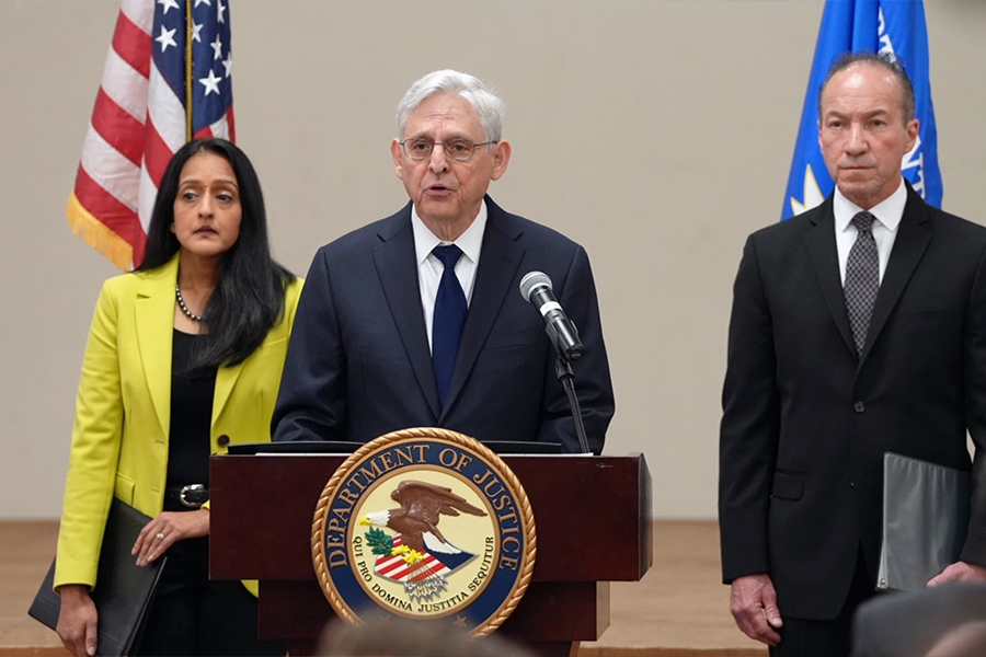 Attorney General Merrick B. Garland delivers remarks from a podium at the Herby Ham Activity Center in Uvalde, Texas. To the left is Associate Attorney General Vanita Gupta and to the right is COPS Director Hugh Clements, Jr.
