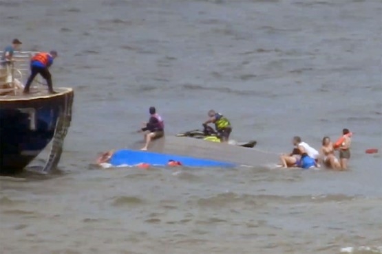 Photo of the capsized vessel and rescue efforts