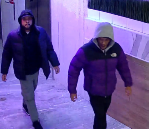 Still image of Hampton and Deckard at the hotel where they robbed Victim-1