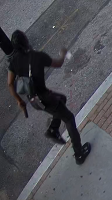 Photo of the defendant running with his gun