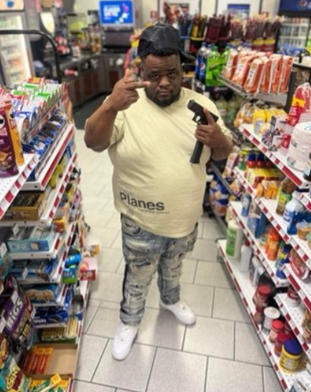 Photograph of Mr. Turner Posing with a Firearm and an Extended Magazine