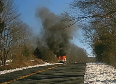 Car burning on side of road 