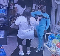 Still image of Derrick Smith Jr. with a loaded rifle inside a convenience store.