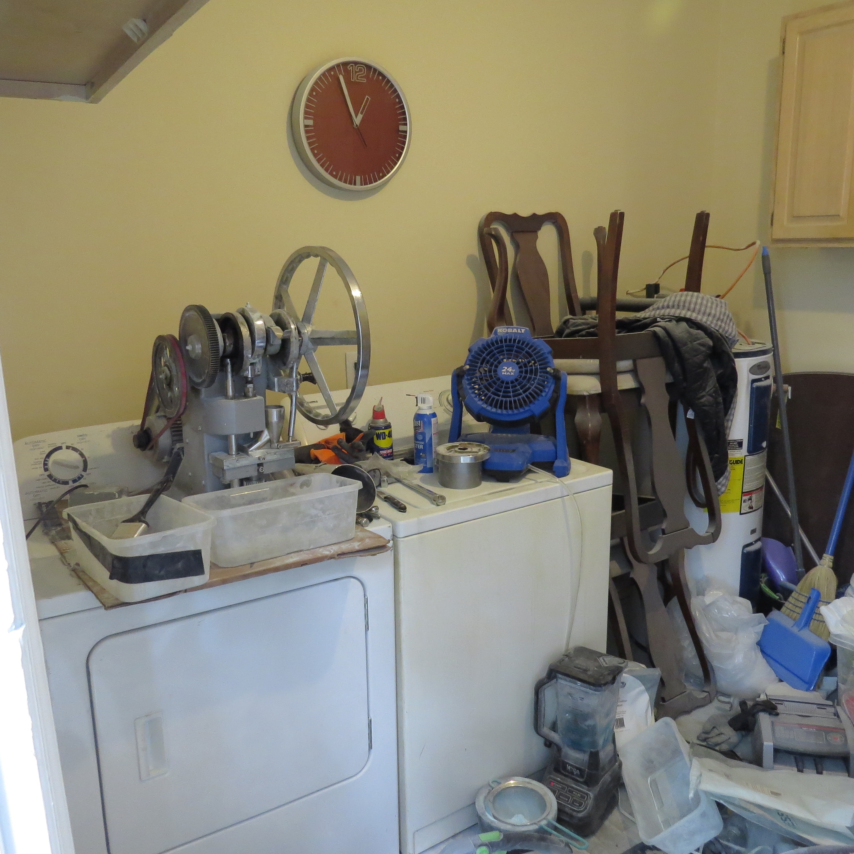 Photo of blue fan and a pill press on top of dryer