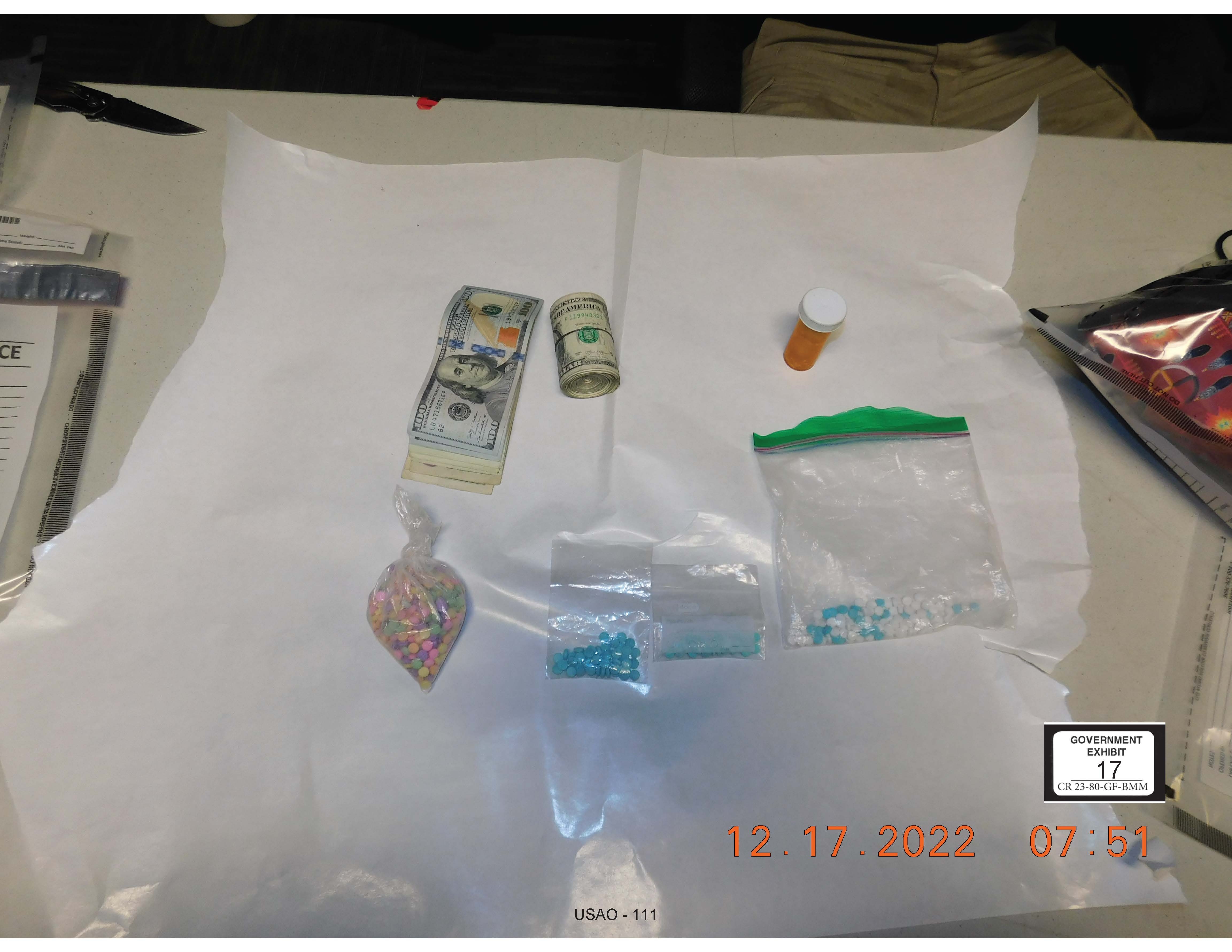 Photo exhibit of fentanyl pills, cash from car