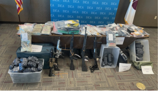 Photo of guns and drugs seized by DEA on October 23, 2024