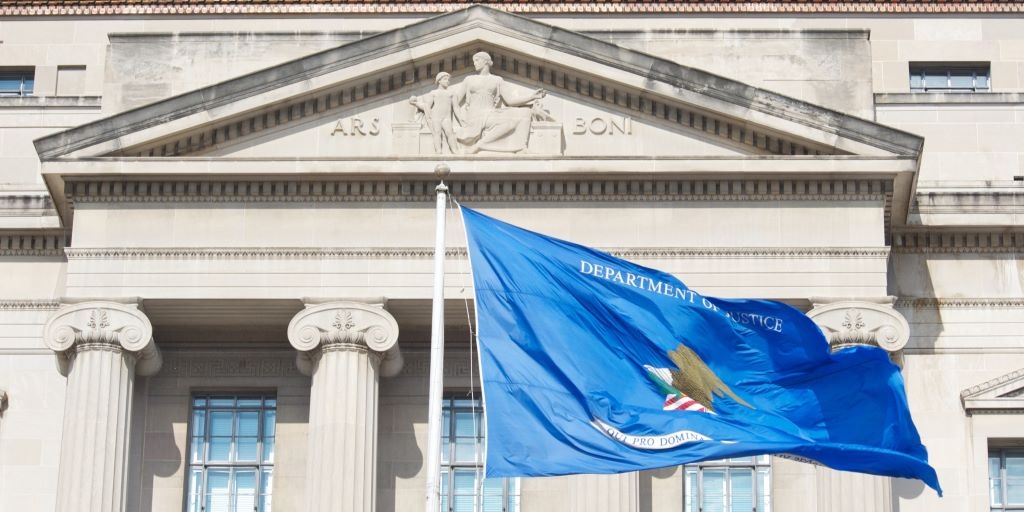 Government building with large pillars in background, Blue flag waving in foreground