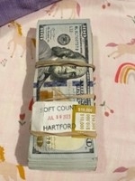 A bundle of cash still wrapped in a paper band stamped with the word “Hartford.”