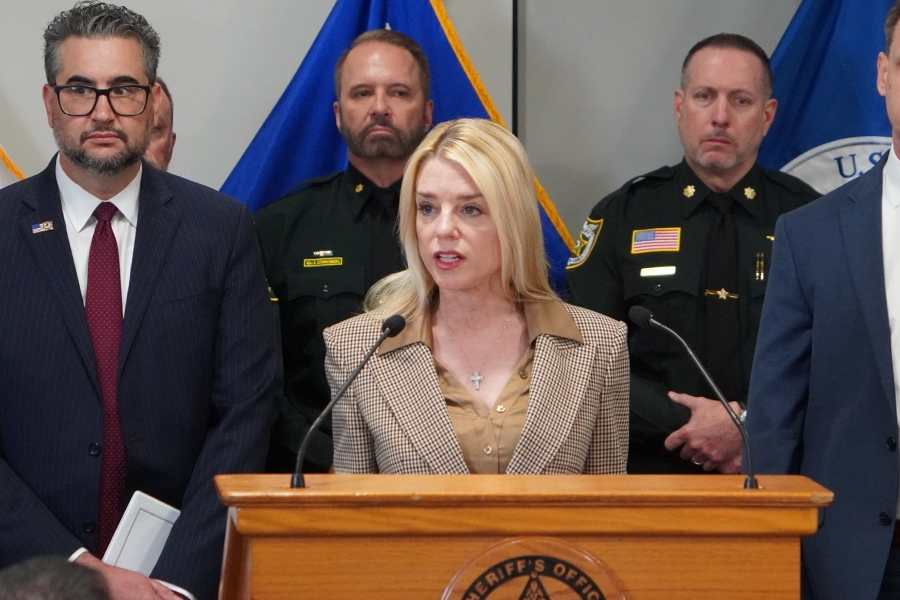 Attorney General Pamela Bondi delivers remarks from a podium at the Broward County Sheriff's Office. She is joined by Broward County Sheriffs and federal government officials.