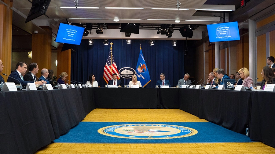 Attorney General Pamela Bondi delivers remarks from the center of a roundtable meeting at the Department of Justice. She is joined by Department of Justice and federal government officials.