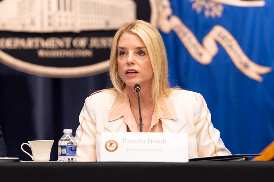 Attorney General Pamela Bondi delivers remarks from the center of a roundtable meeting at the Department of Justice. She is joined by Department of Justice and federal government officials.