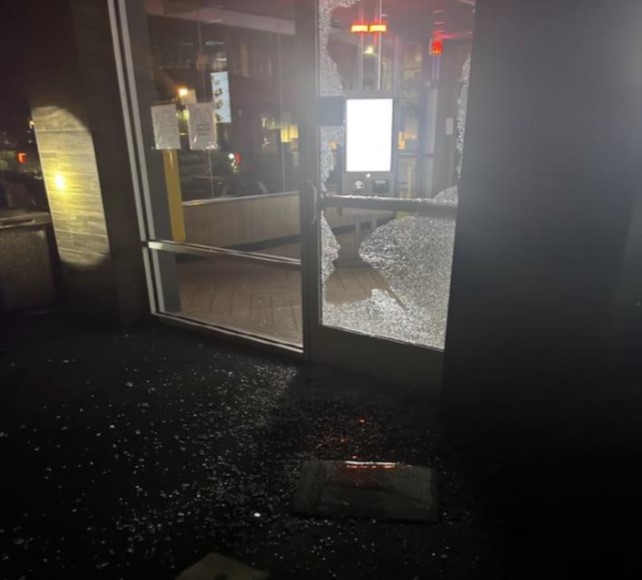 Depicts exterior glass door and window with glass smashed and broken.
