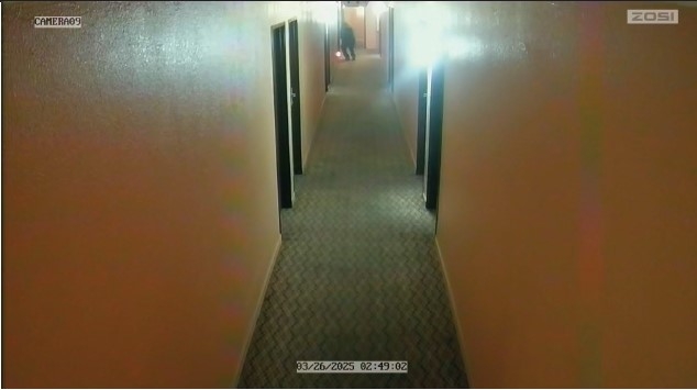 A still image from surveillance video showing someone starting a fire.