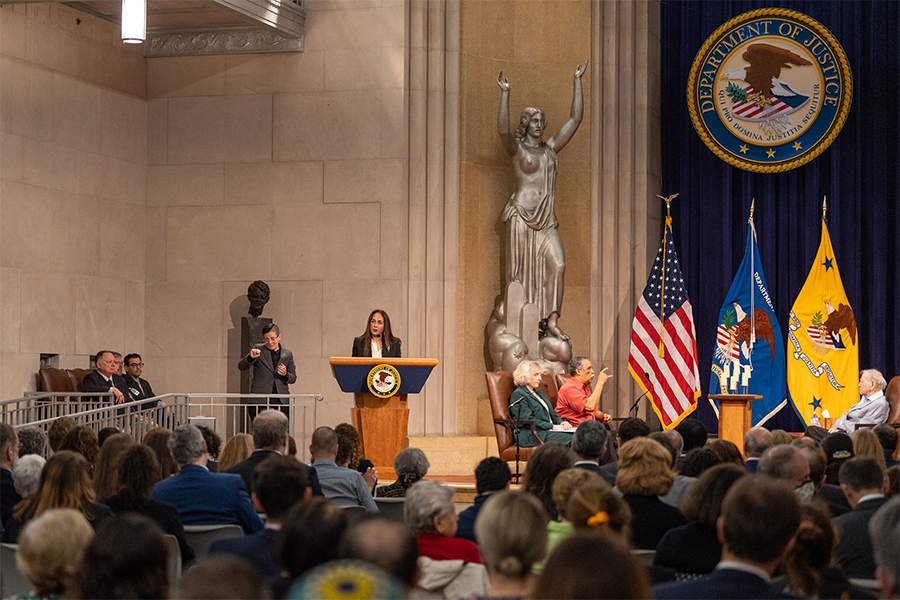 Assistant Attorney General for Civil Rights Harmeet Dhillon delivers remarks from a podium in the Great Hall at the Department of Justice.