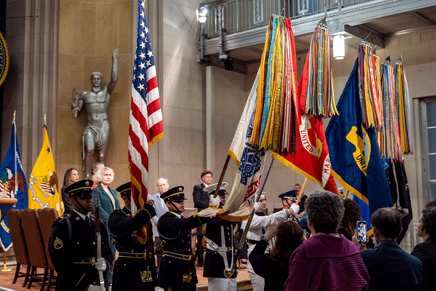 United States Color Guard members present the colors during the national anthem.