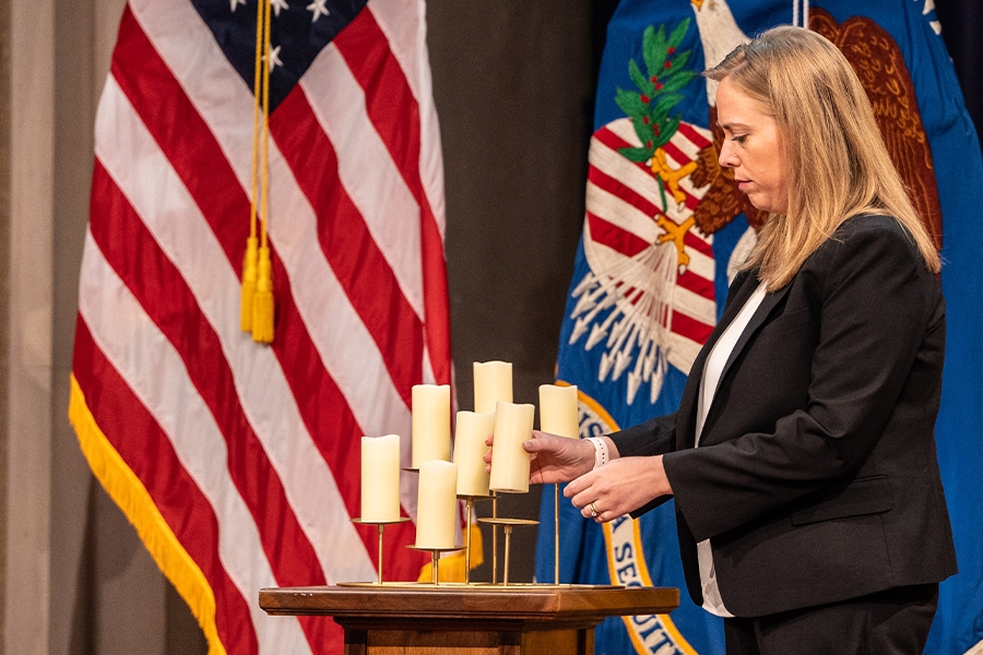 Pictured: Acting Chair of the Equal Employment Opportunity Commission Andrea Lucas lights a candle in remembrance.