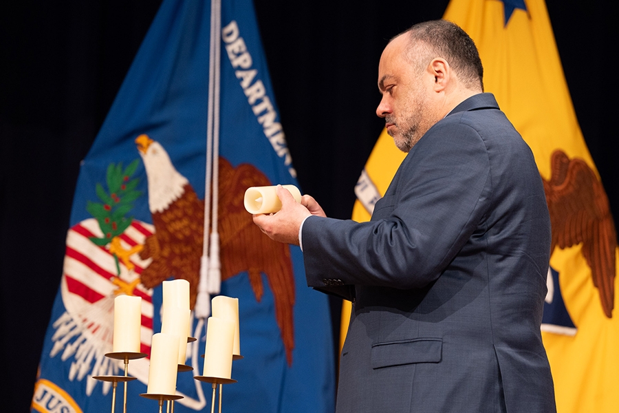 Pictured: Acting Chair of the Merit Systems Protection Board Henry Kerner lights a candle in remembrance.