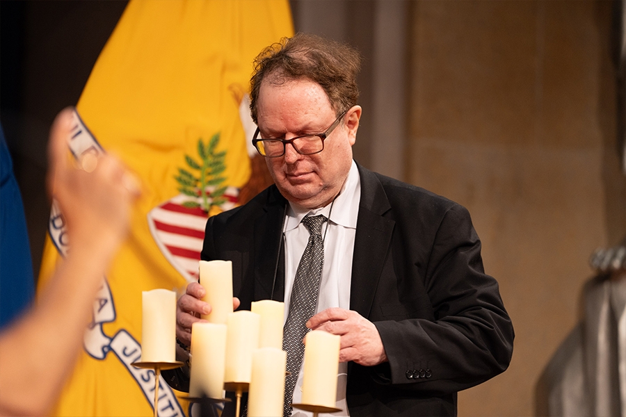 Pictured: Deputy Assistant General Counsel for Environment at the Department of Energy Steven Miller lights a candle in remembrance.