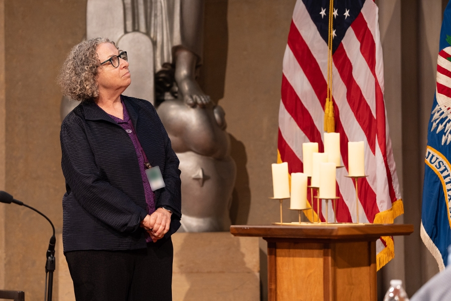 Pictured: Chair Emeritus of the Federal Interagency Holocaust Remembrance Committee Eva Fontheim lights a candle in remembrance.