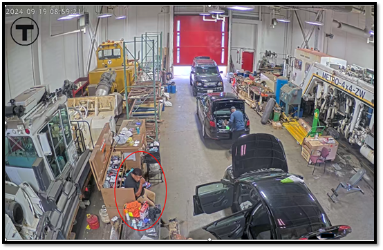 Vicente (circled in red below) sitting inside of Cabot Garage holding his cellular phone