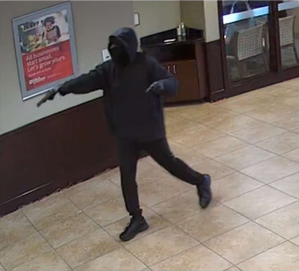 Still photo of Guliford pointing gun