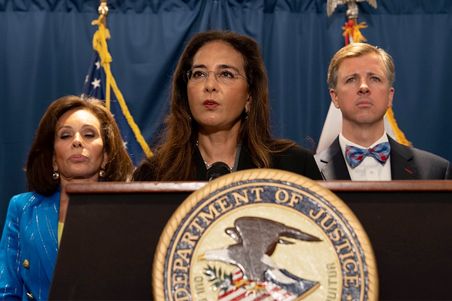 Assistant Attorney General Harmeet K. Dhillon delivers remarks from a podium at the U.S. Attorney’s Office for the District of Columbia. She is joined by federal and government officials.