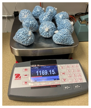Bags of blue pills on a scale