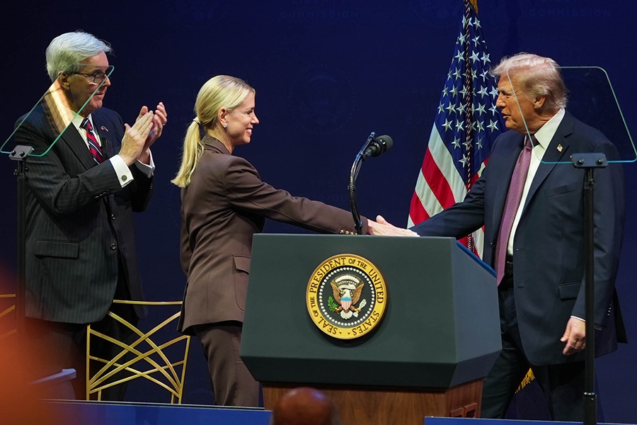 U.S. President Donald Trump shakes hands with U.S. Attorney General Pamela Bondi for the second hearing on religious liberty in public education.