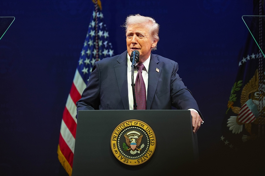 President Donald J. Trump delivers remarks from a podium at the Museum of the Bible in Washington, D.C. He is joined by Attorney General Pamela Bondi and members of the Religious Liberty Commission.