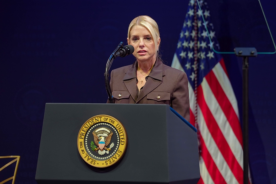 Attorney General Pamela Bondi delivers remarks from a podium at the Museum of the Bible in Washington, D.C. She is joined by members of the Religious Liberty Commission.