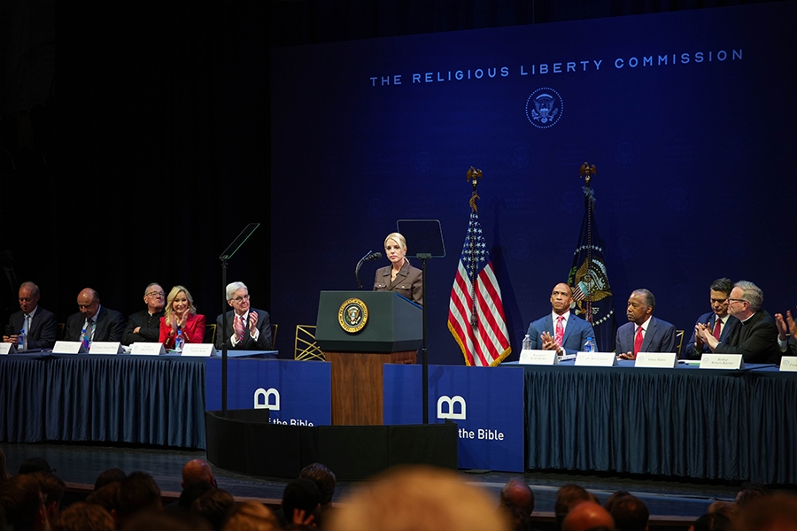 Attorney General Pamela Bondi delivers remarks from a podium at the Museum of the Bible in Washington, D.C. She is joined by members of the Religious Liberty Commission.