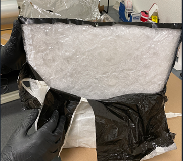 One block of meth wrapped in white and black plastic.