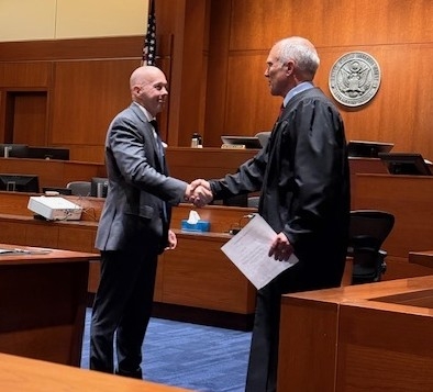 Scott Bradford swearing in with Judge Mosman