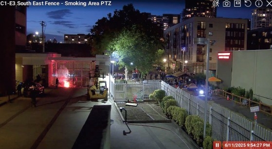 surveillance photo showing a small fire next to the building