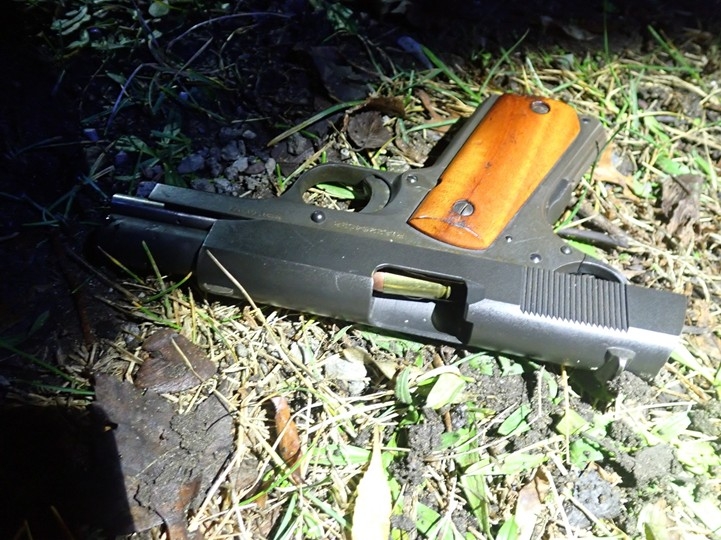 Image of loaded pistol on the ground