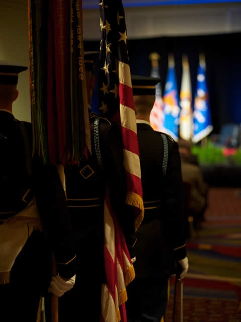 View from behind the color guard as they enter for the commencement of the ceremony.