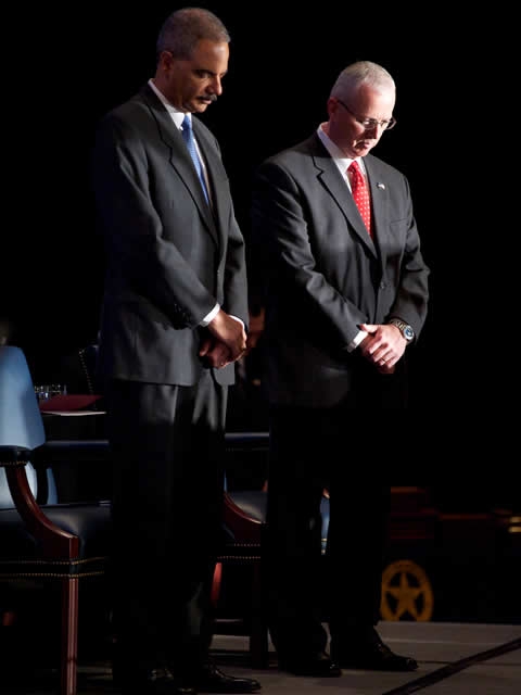 Attorney General Holder and Director Clark showing respect during the invocation.