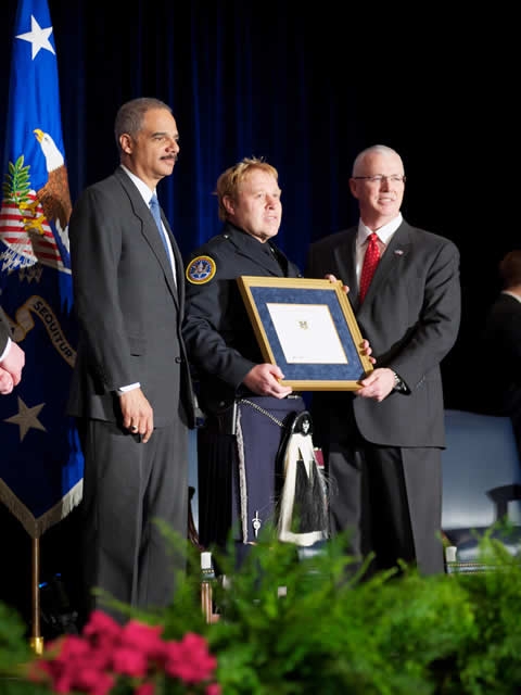 Chief Inspector Joel Kirch posing with AG Holder and Director Clark after receiving the Operational Employee of The Year Award.