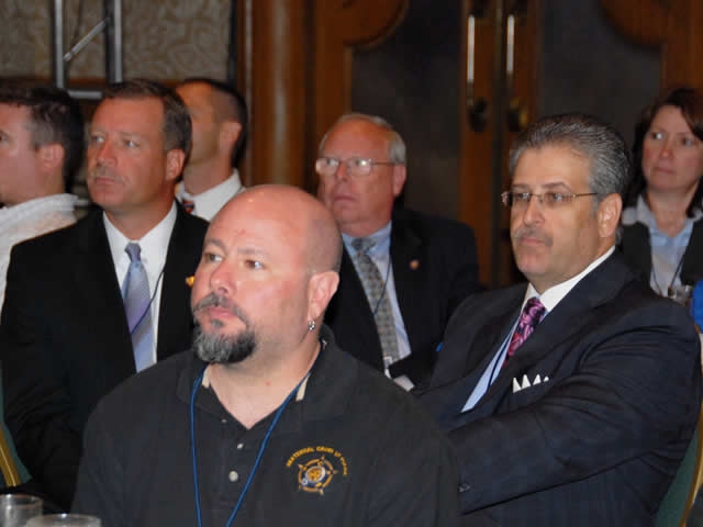 Conference participants listen attentively during the AG's address and pledge.