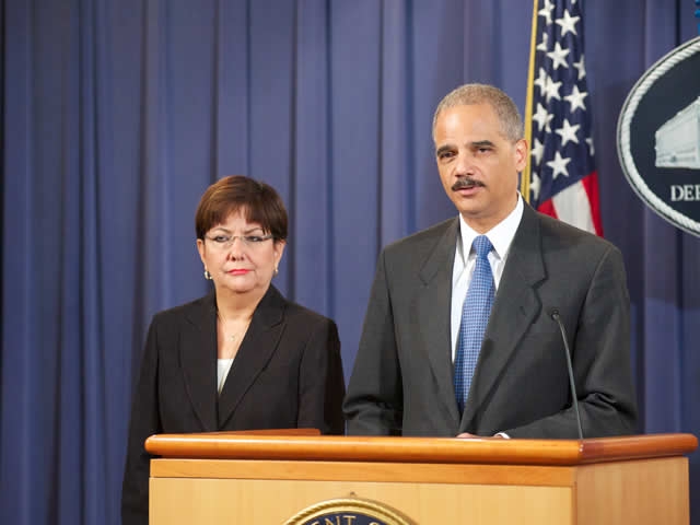Attorney General Eric Holder flanked by U.S. Attorney Rosa Emilia Rodriguez-Velez, Puerto Rico
