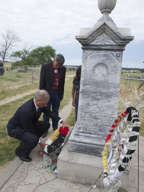 Attorney General Holder lays a wreath at the Wounded Knee Memorial Site