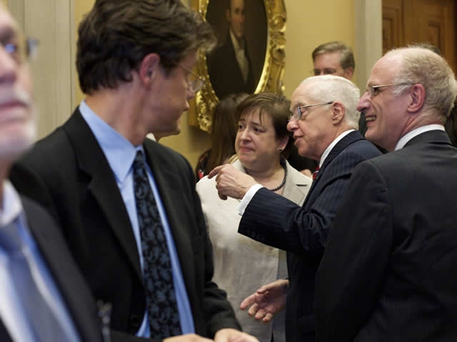 Former Attorney General Michael Mukasey speaks with Solicitor General Kagan.