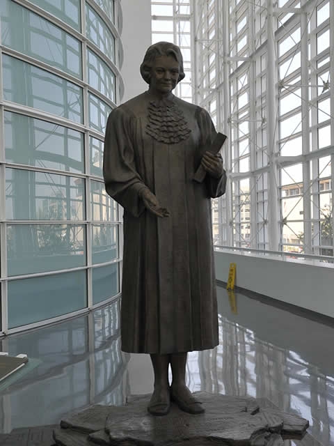 Statue of former Supreme Court Justice Sandra Day O'Connor within the court building bearing her name.