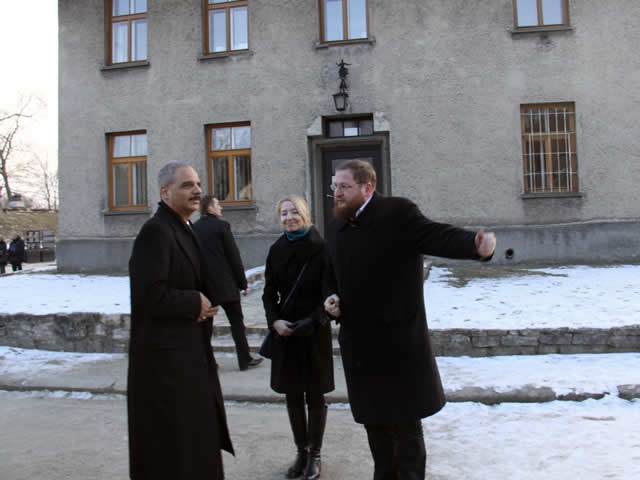 U.S. Attorney General Eric Holder is greeted at the Auschwitz-Birkenau Memorial and State Museum by Museum Director Piotr Cywinski.