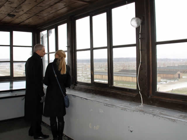 Attorney General Holder, with guide, surveys the Birkenau concentration camp from the watchtower at the the Auschwitz-Birkenau Memorial and State Museum.