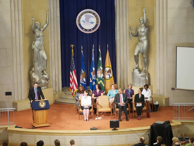 The view of the dais at the sexual assault awareness month commemoration, celebration of progress, and recommitment event.